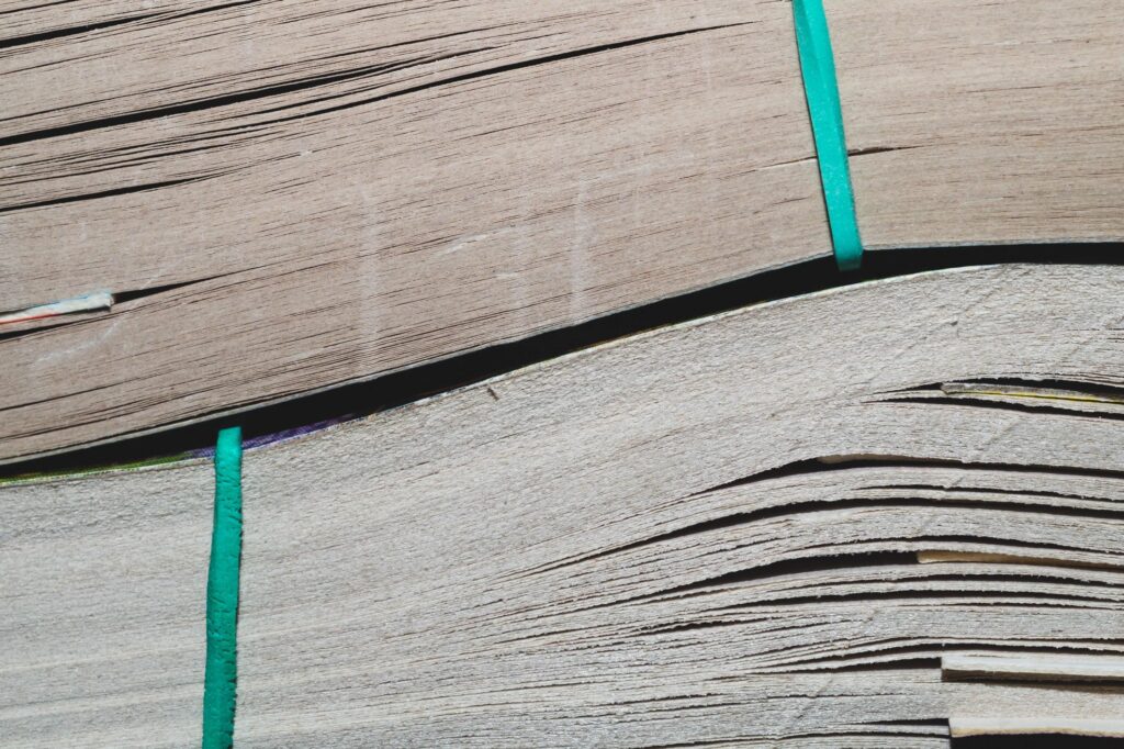 Book with soft cover. paperback close up. book edge. pages pulled together with an elastic band