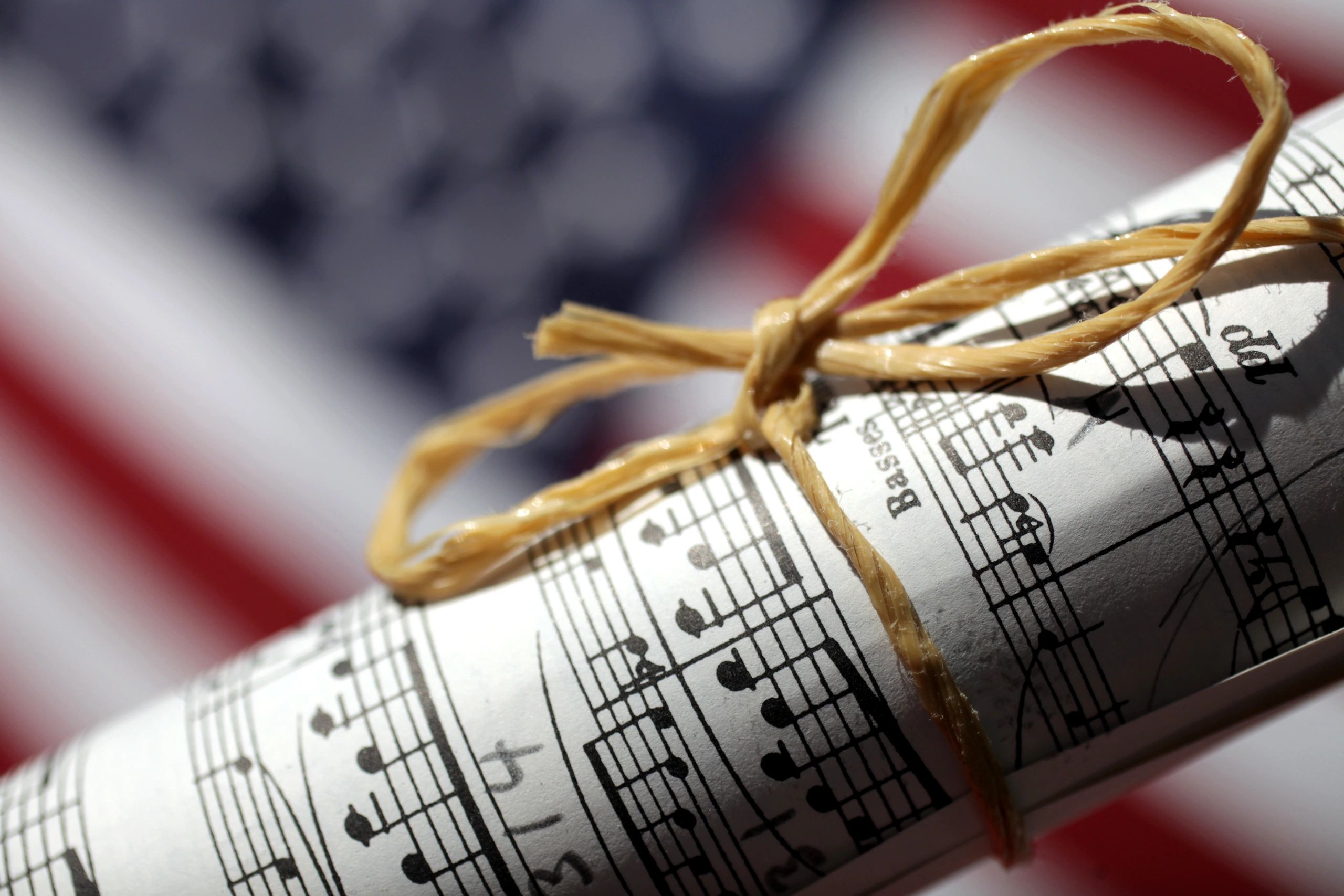 Rolled sheet music in dramatic light